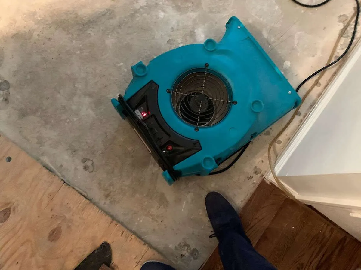 Air mover drying subfloor during Commercial Water Damage Restoration in Rock Falls